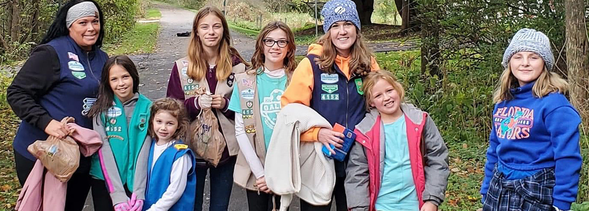 Slideshow Image - A girl scout trooping helping clean the B&O trail