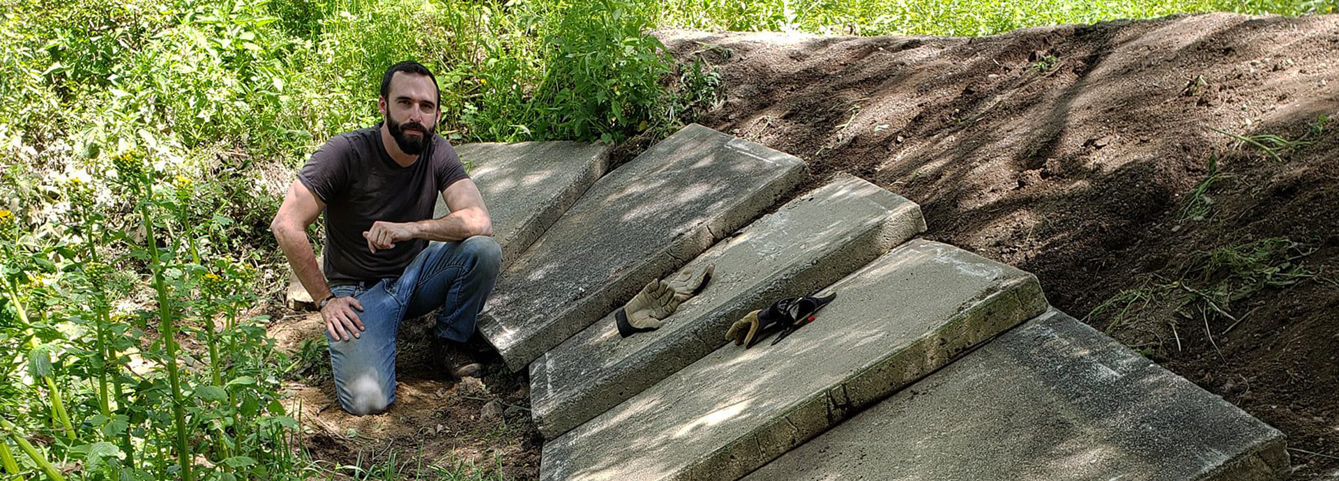 Slideshow Image - A staff member helping to repair a sidewalk